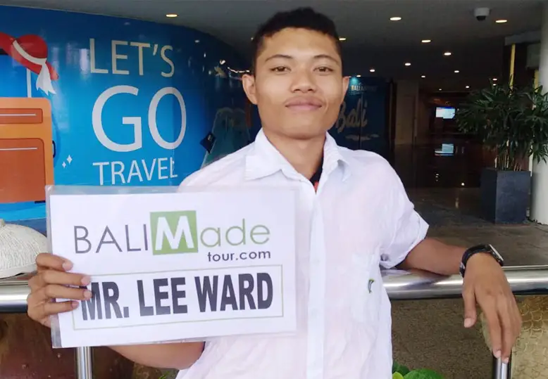 Driver Holding Sign With Customer Name at Arrival Hall - Bali Airport Transfer
